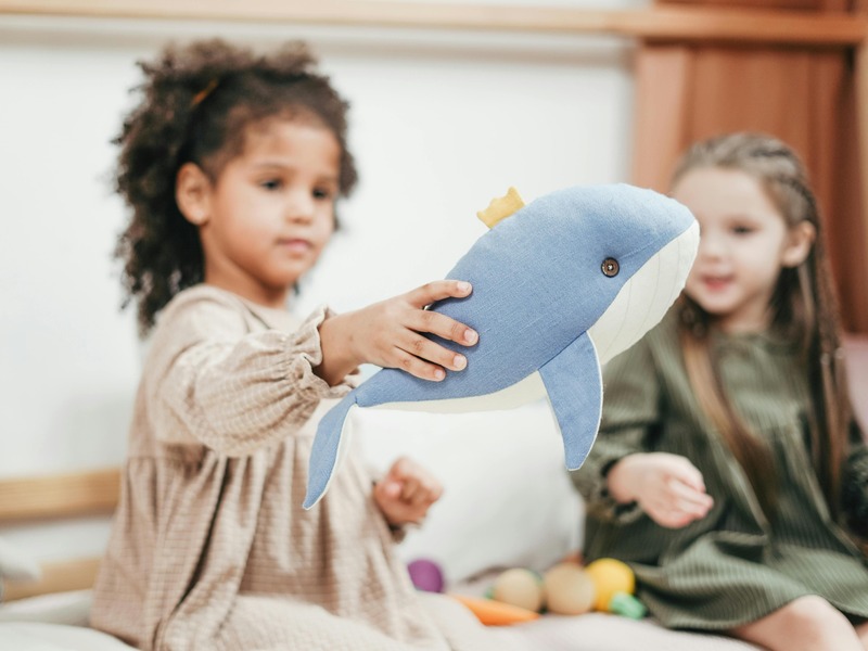 child playing with a stuffed animal